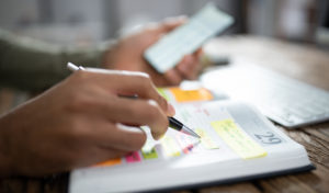 person writing in planner